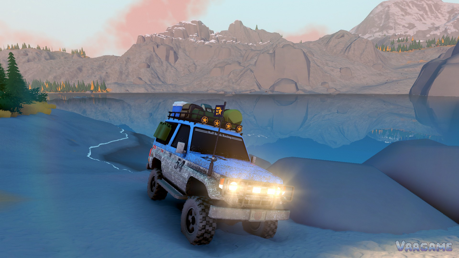 A mud-caked SUV with its lamps blazing on a frozen lakeshore at dusk