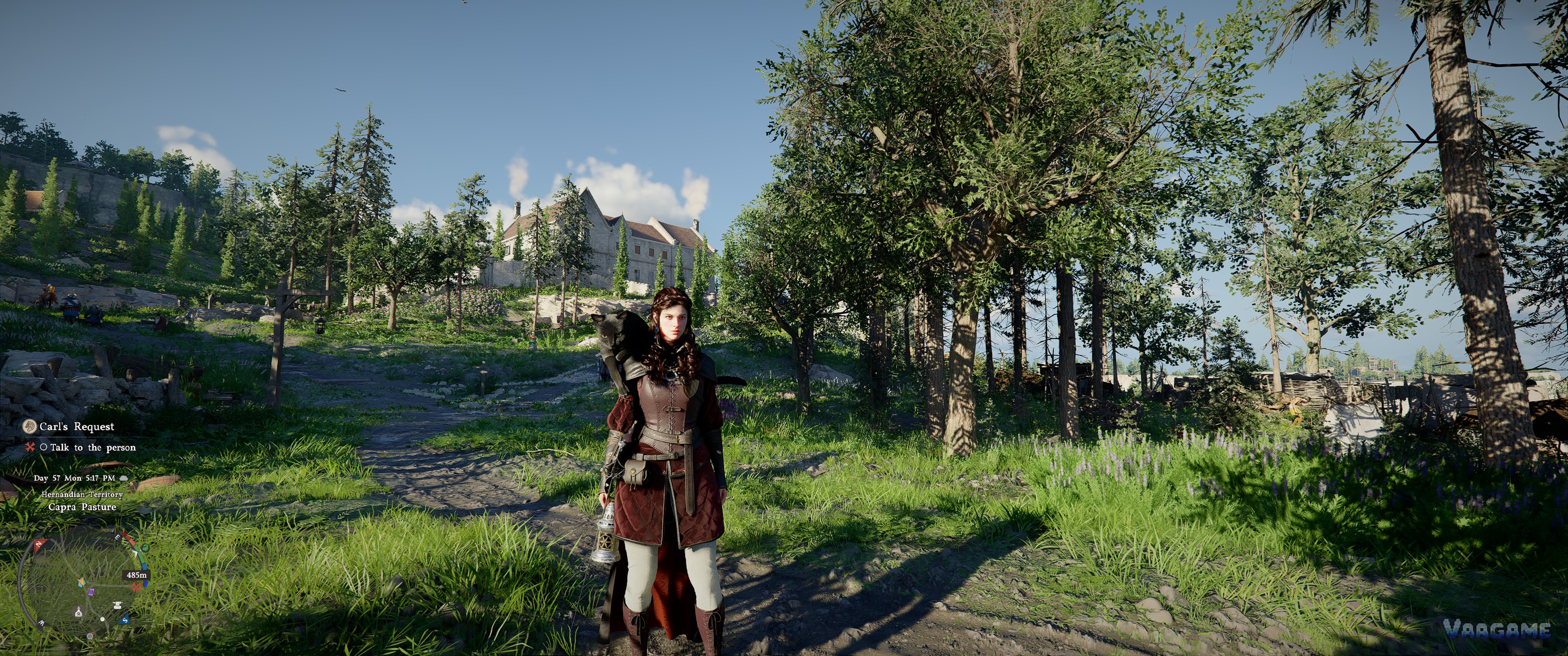 Crimson Desert character standing in a green pasture near a stone building