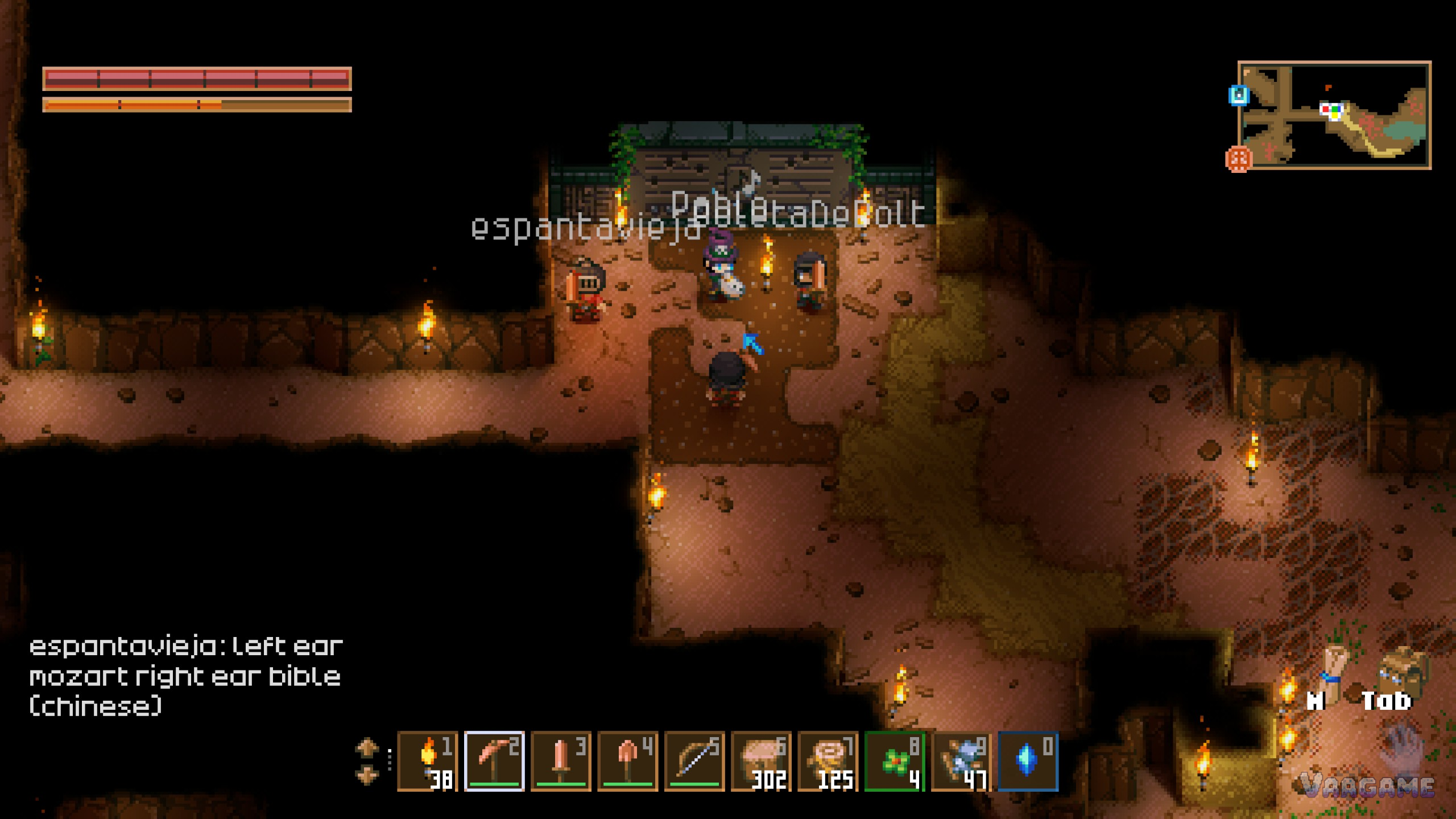 Four players gathered at a ruins doorway, English chat running in the corner