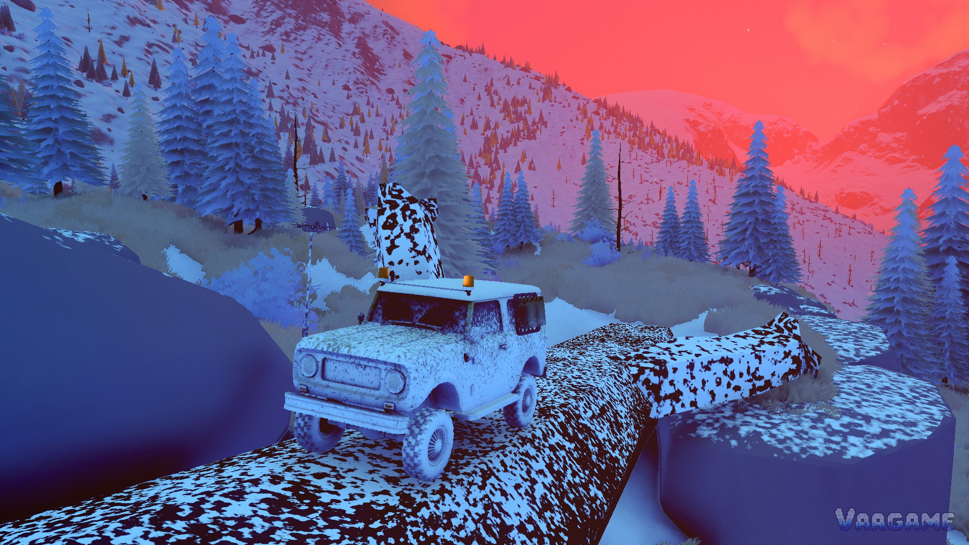 A speckled wagon crossing a snow-dusted log bridge over a gully at dusk