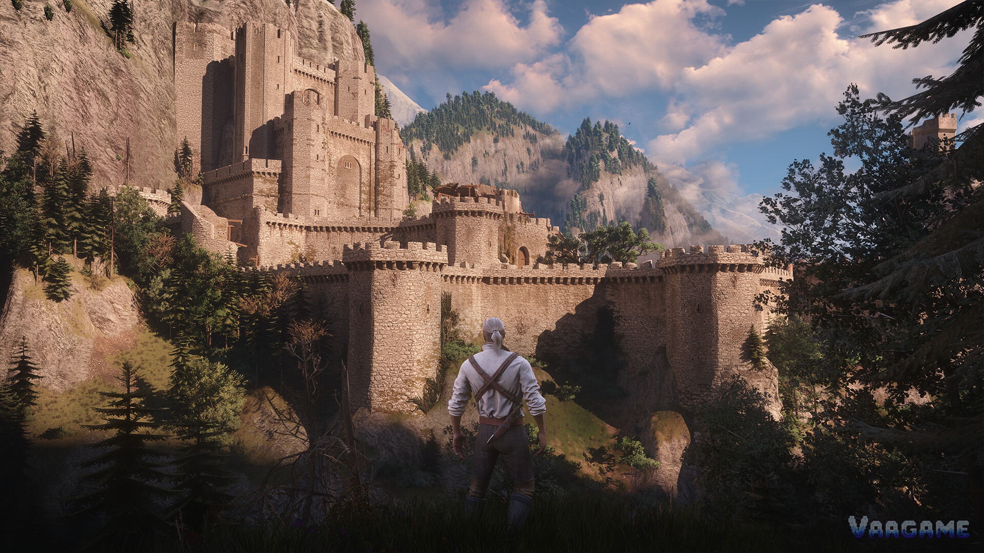 Geralt standing before the fortress of Kaer Morhen, built into the mountainside