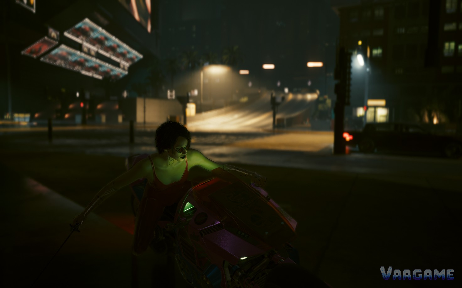 V riding a motorcycle through a dark street at night in Cyberpunk 2077