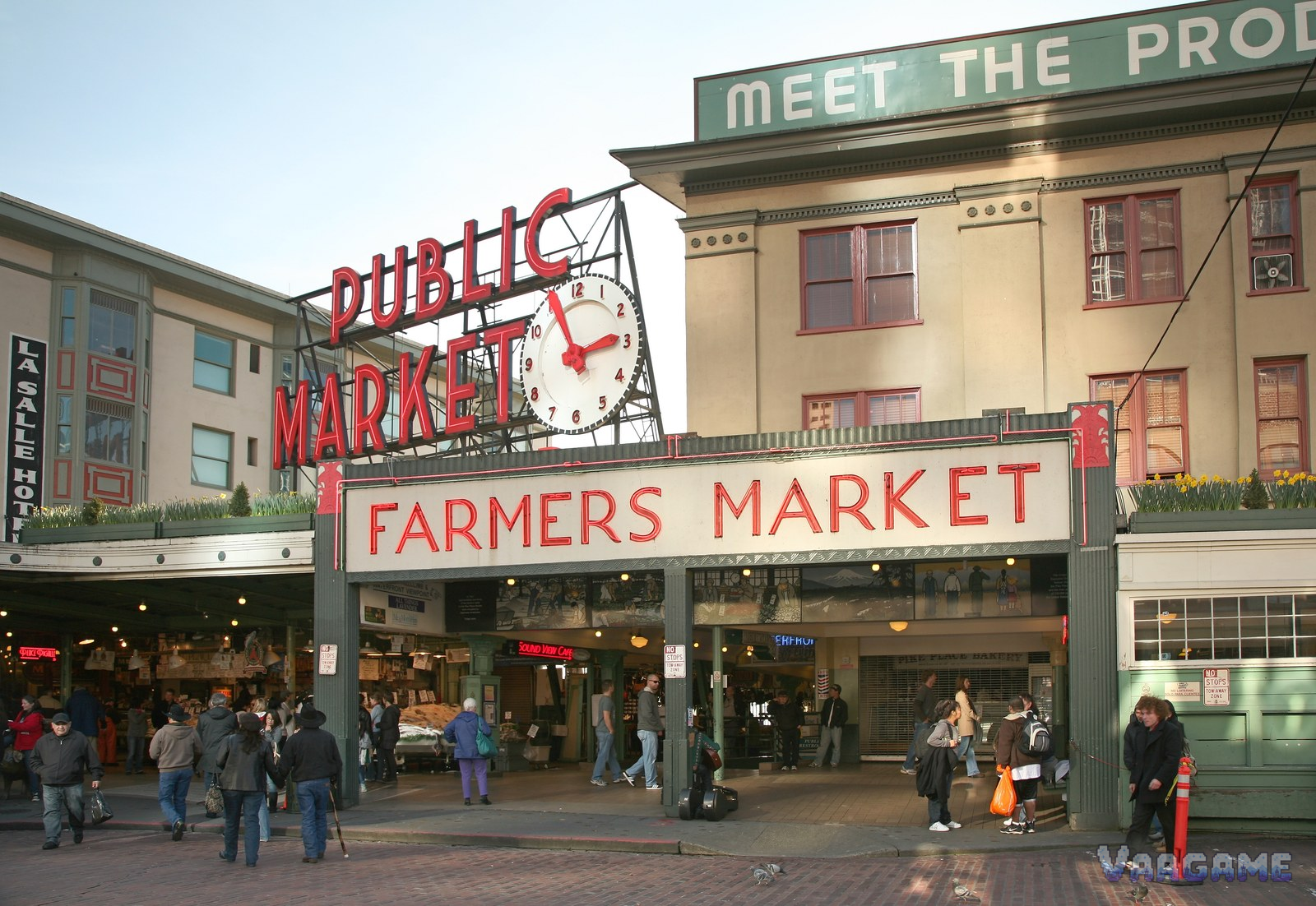 Pike Place Market Public Market sign and clock with Farmers Market entrance in daylight