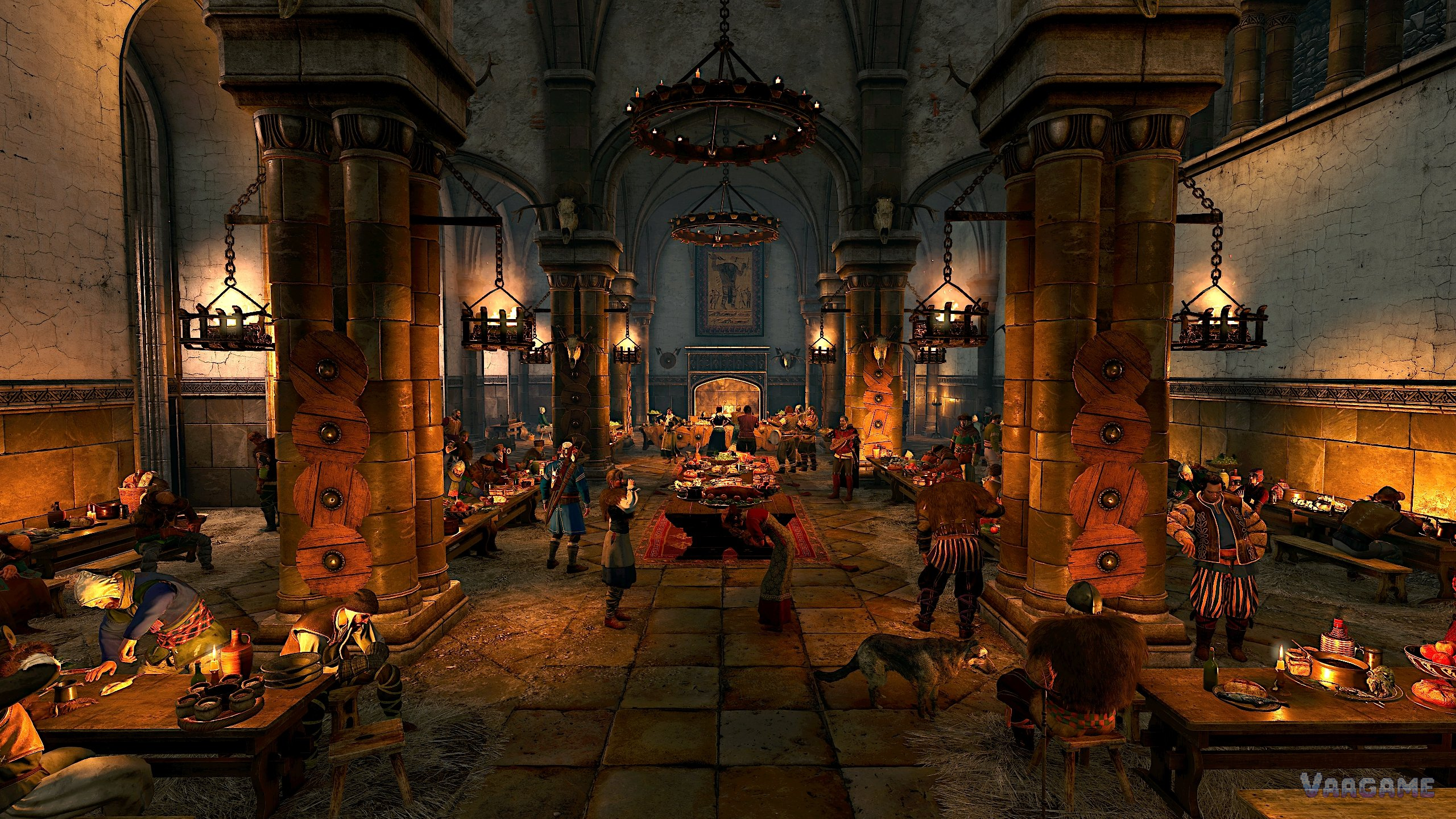 A crowded feast hall with long tables and hanging chandeliers