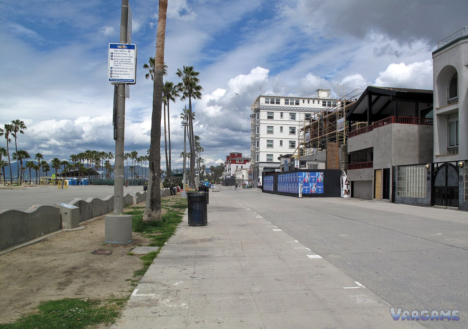 Ocean Front Walk promenade with palm trees and beach in Venice Los Angeles