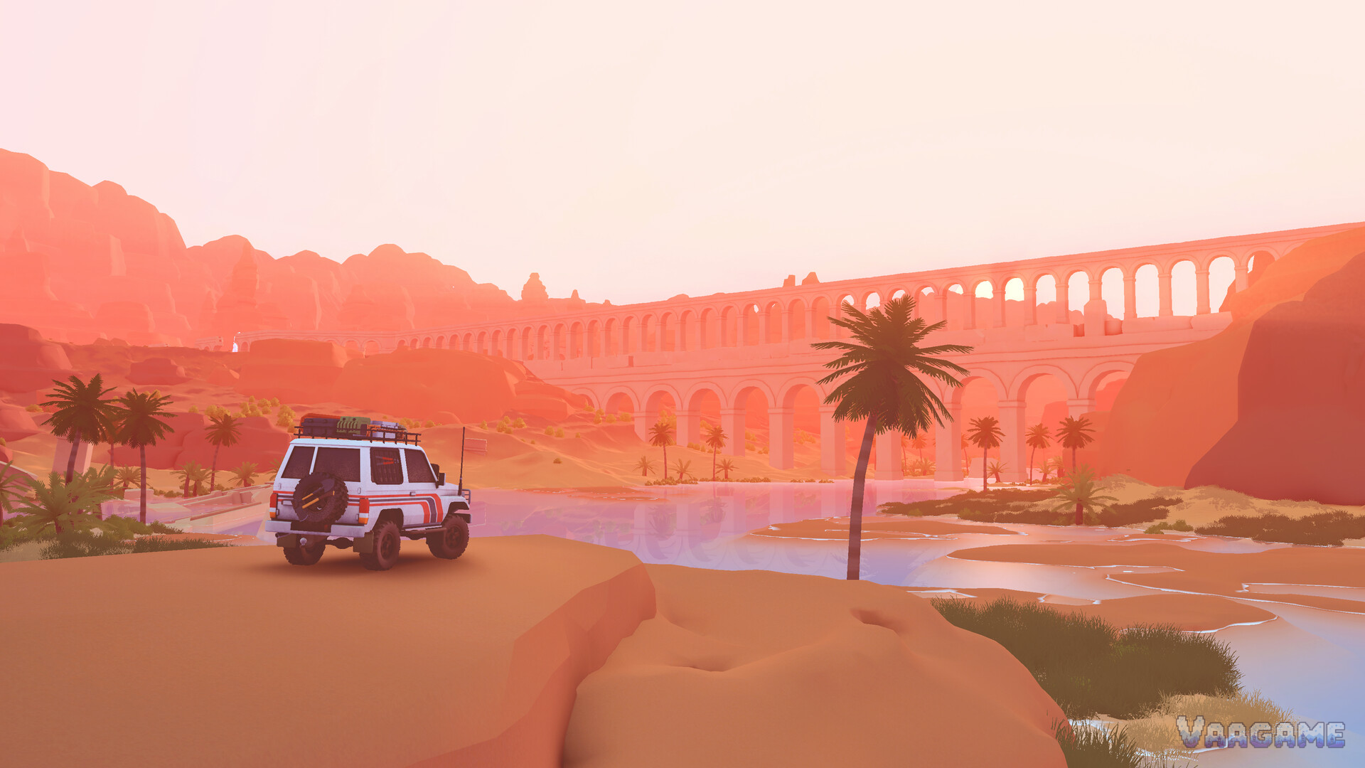A white and red SUV beside a desert lake with palms and a long arched aqueduct at sunset
