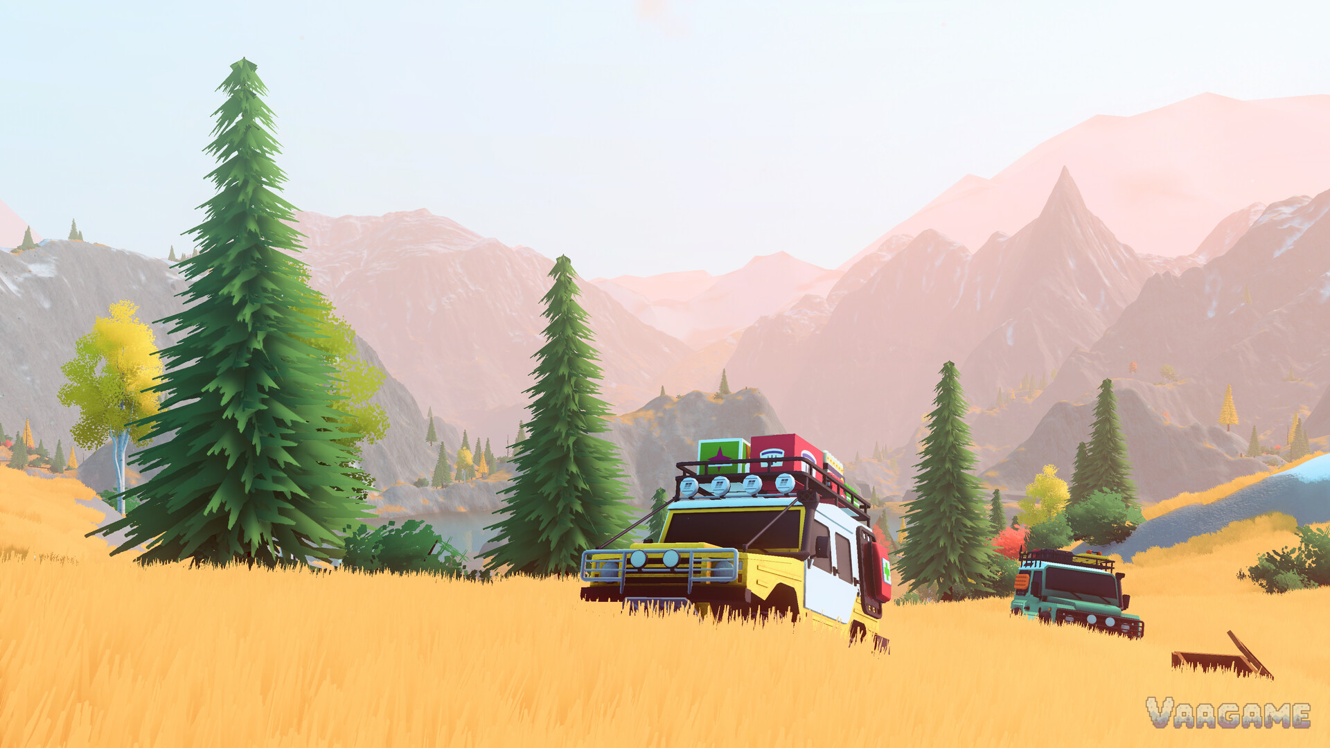 Two 4x4 vehicles crossing a golden meadow beneath pine trees and mountains in over the hill
