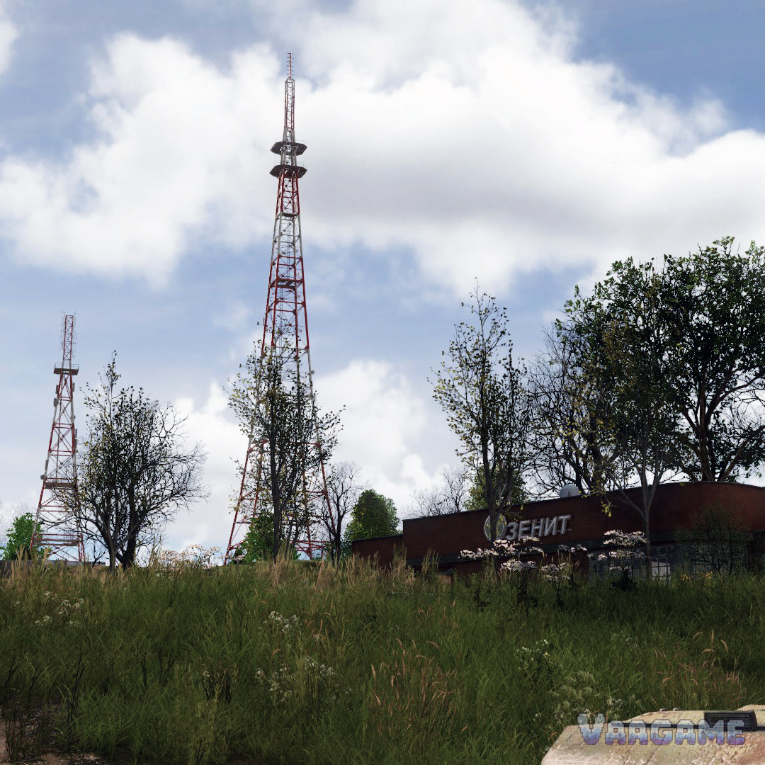 A transmission tower rising over the fields