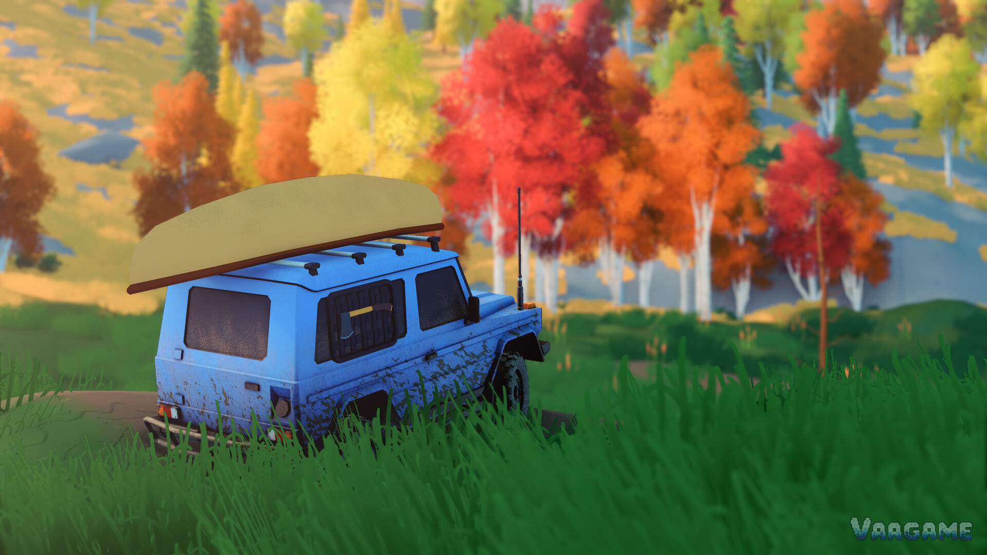 A blue 4x4 with a canoe on its roof rack parked in autumn woodland in over the hill