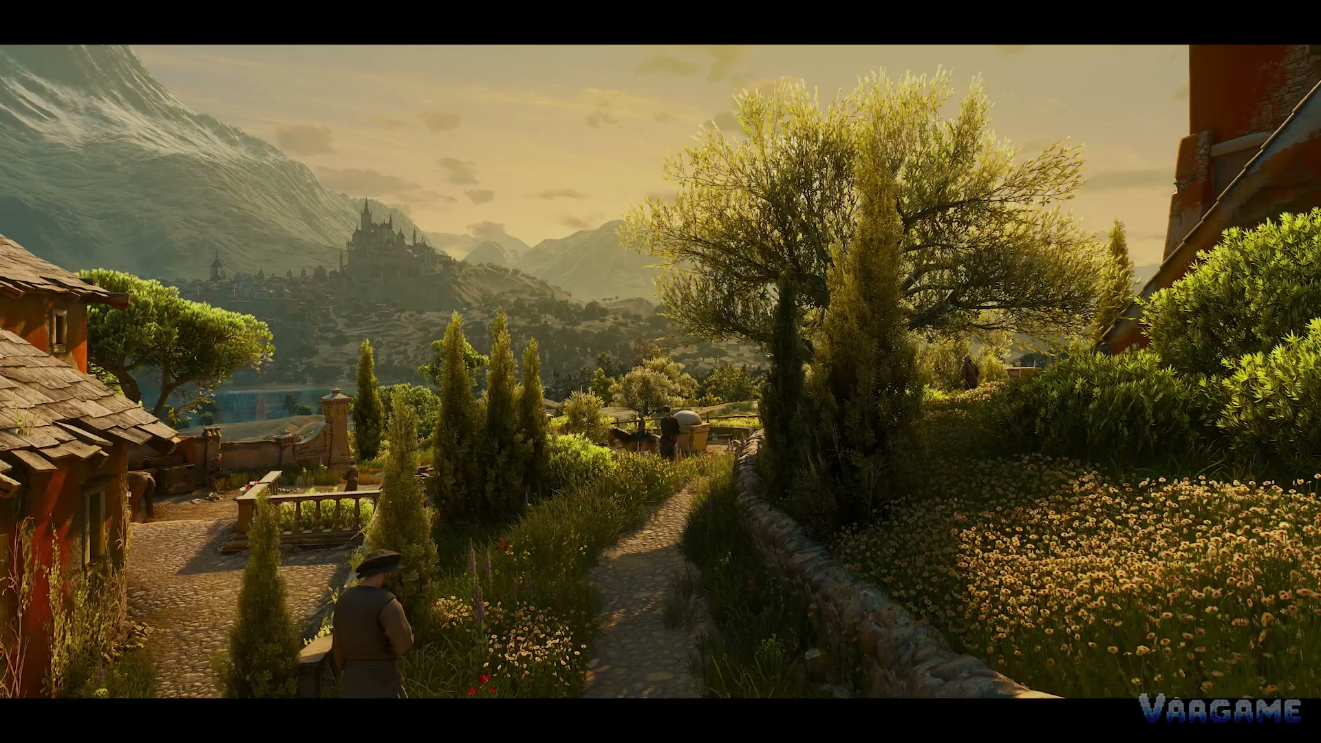 A cobbled lane in Toussaint: cypress trees, flower beds and Beauclair on its hill