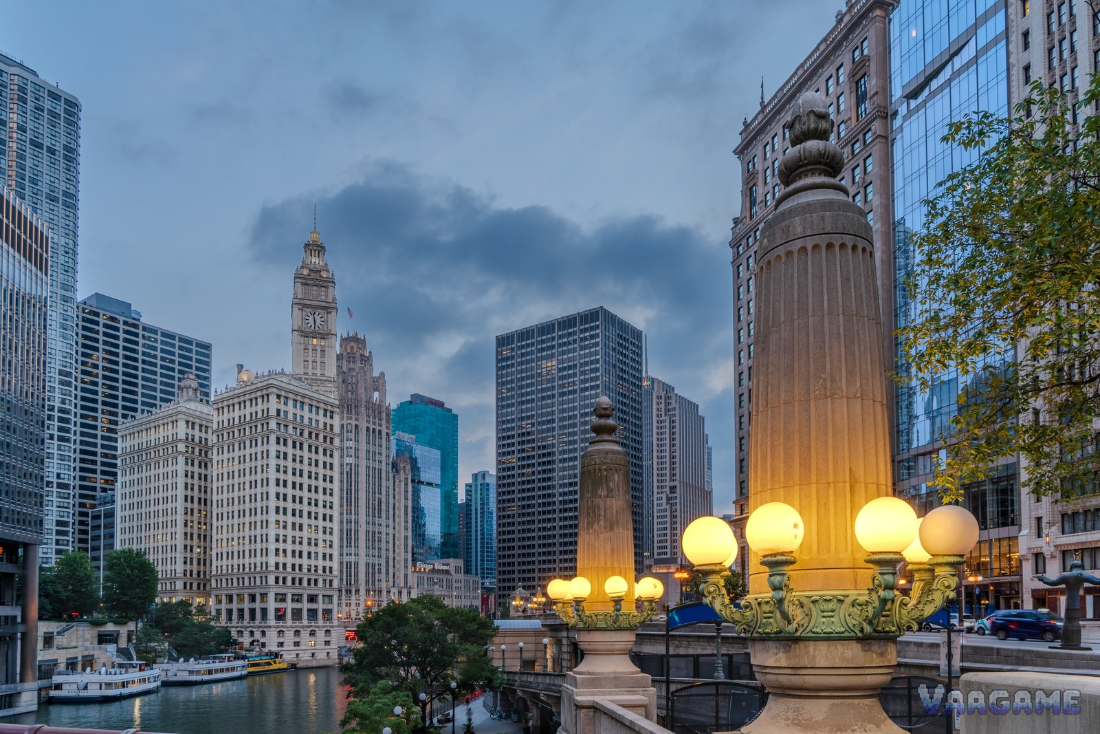Chicago River at blue hour with Wrigley Building and bridge lamps
