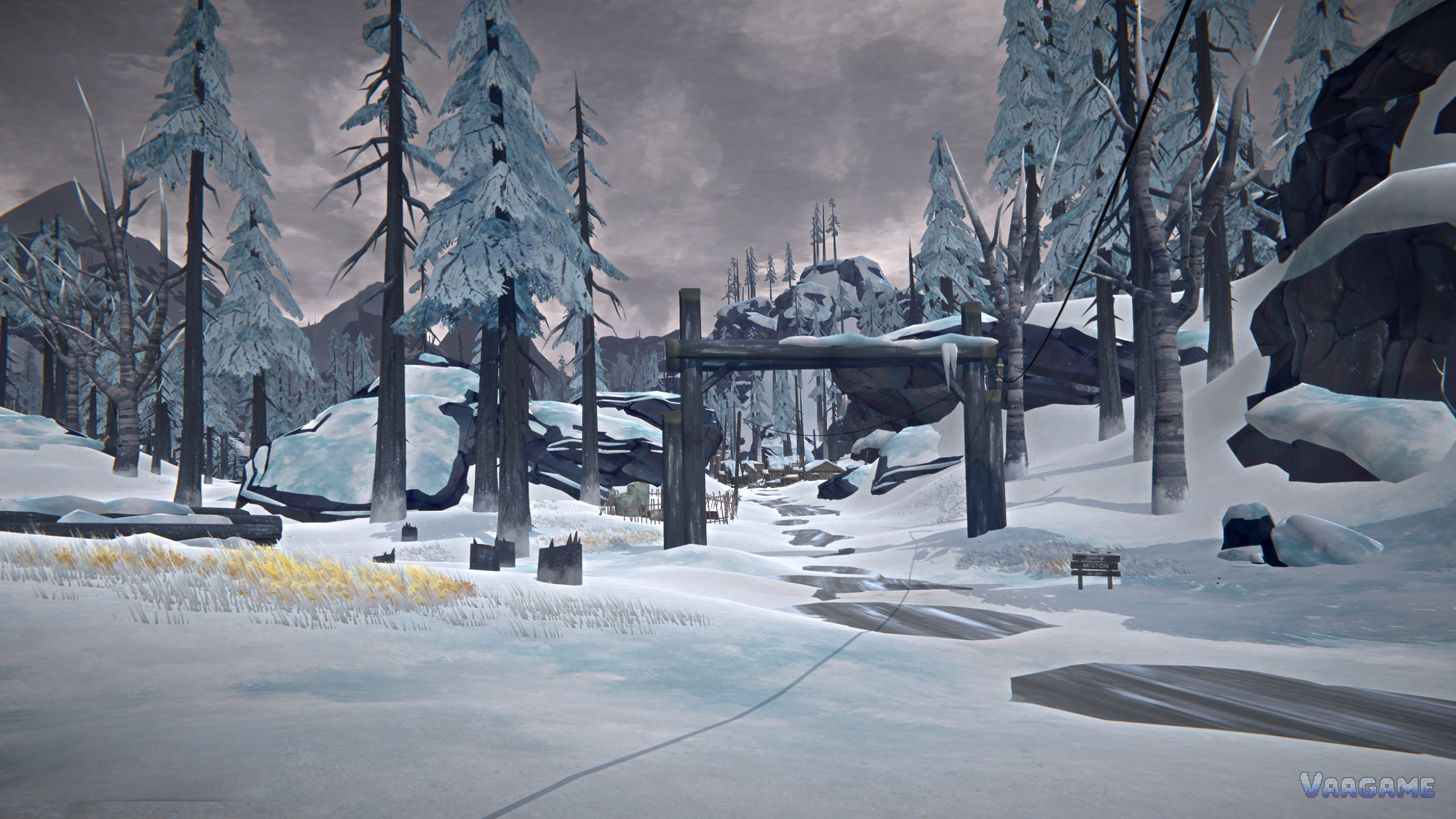 Snowy road and wooden gate in the forest