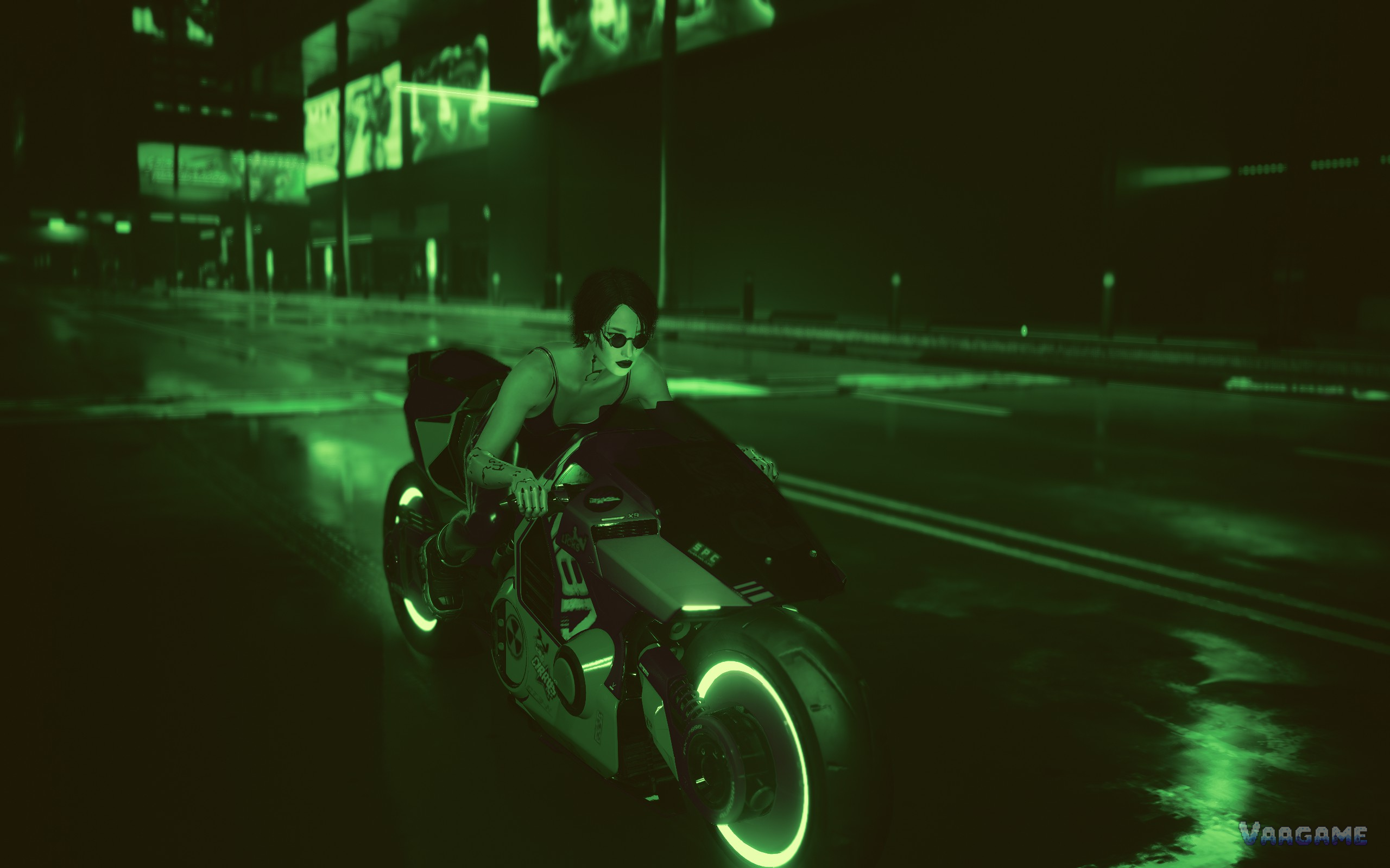 V riding a motorcycle through a green lit street at night in Cyberpunk 2077