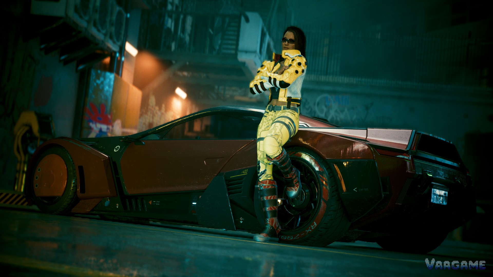 V in a yellow outfit posing beside a sports car at night