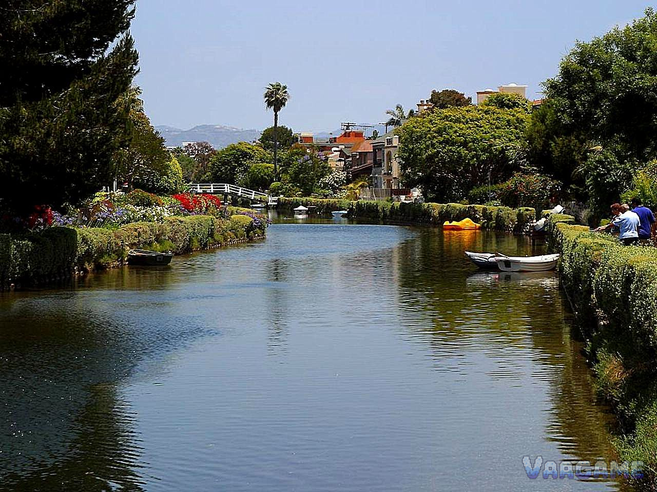 Venice Beach canals with a white footbridge and boats