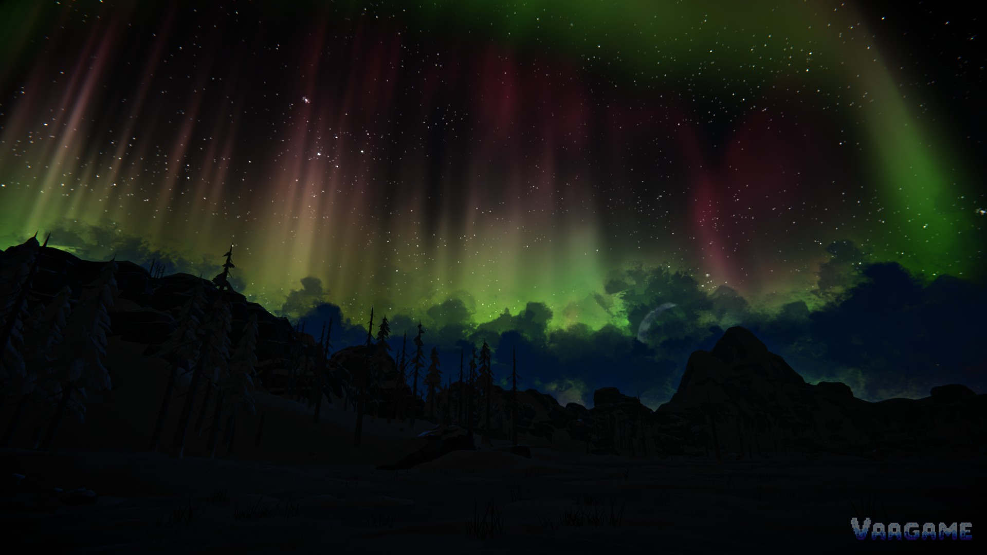 Red and green aurora over dark mountains