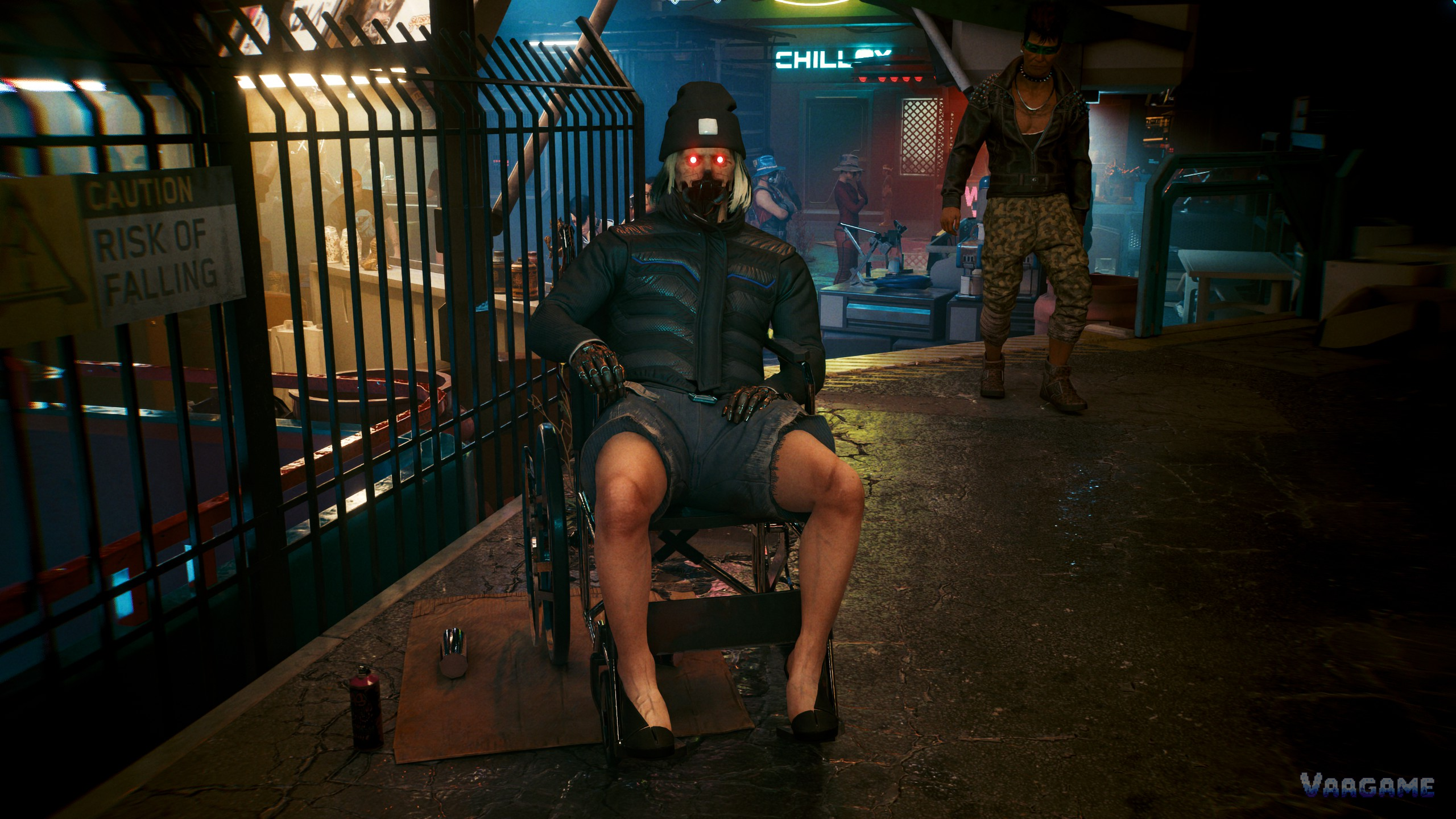 A man in a wheelchair on a Night City street at night