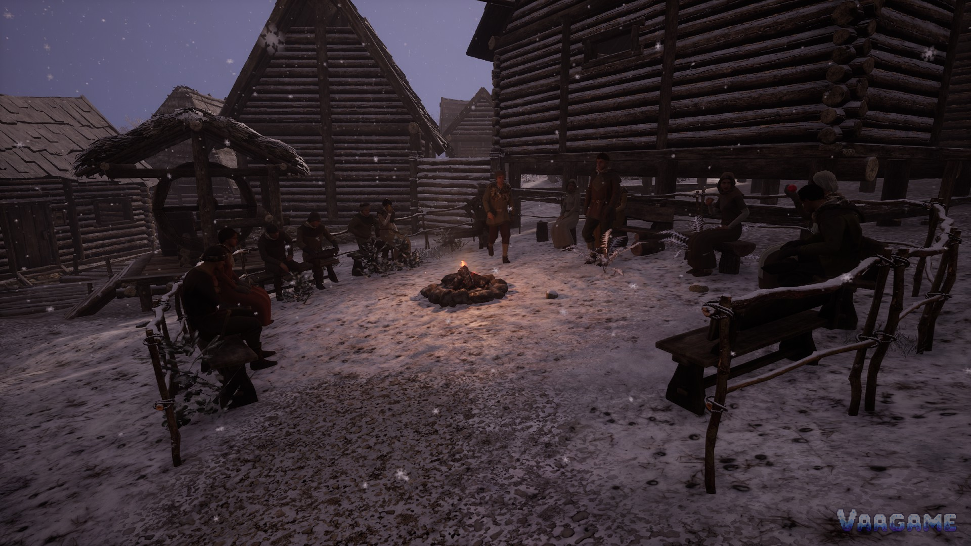 Villagers gathered around a campfire in snow at dusk