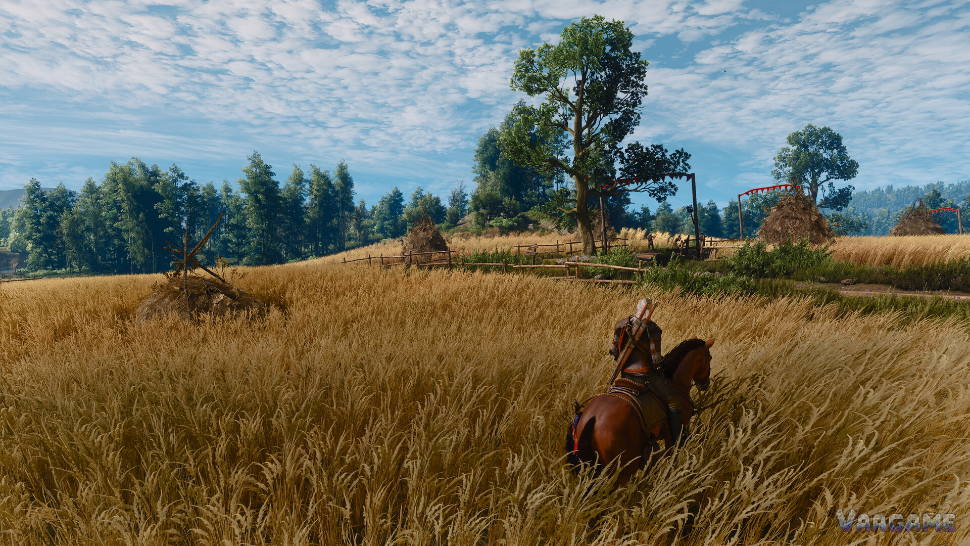 Geralt riding through a golden wheat field toward a large oak