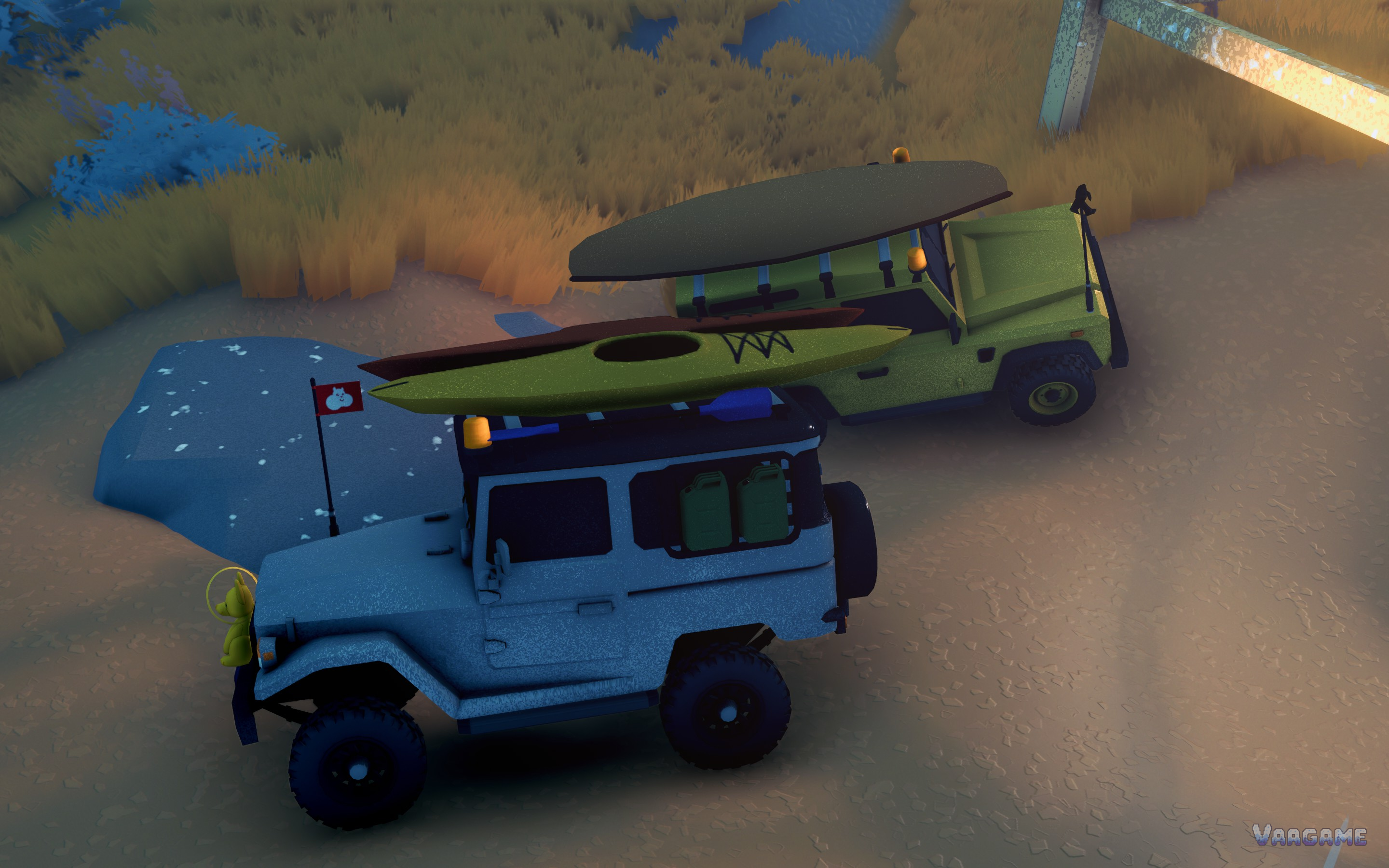 Two wagons at dusk carrying kayaks and boards on their roof racks